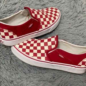 Red slip on checkered vans.